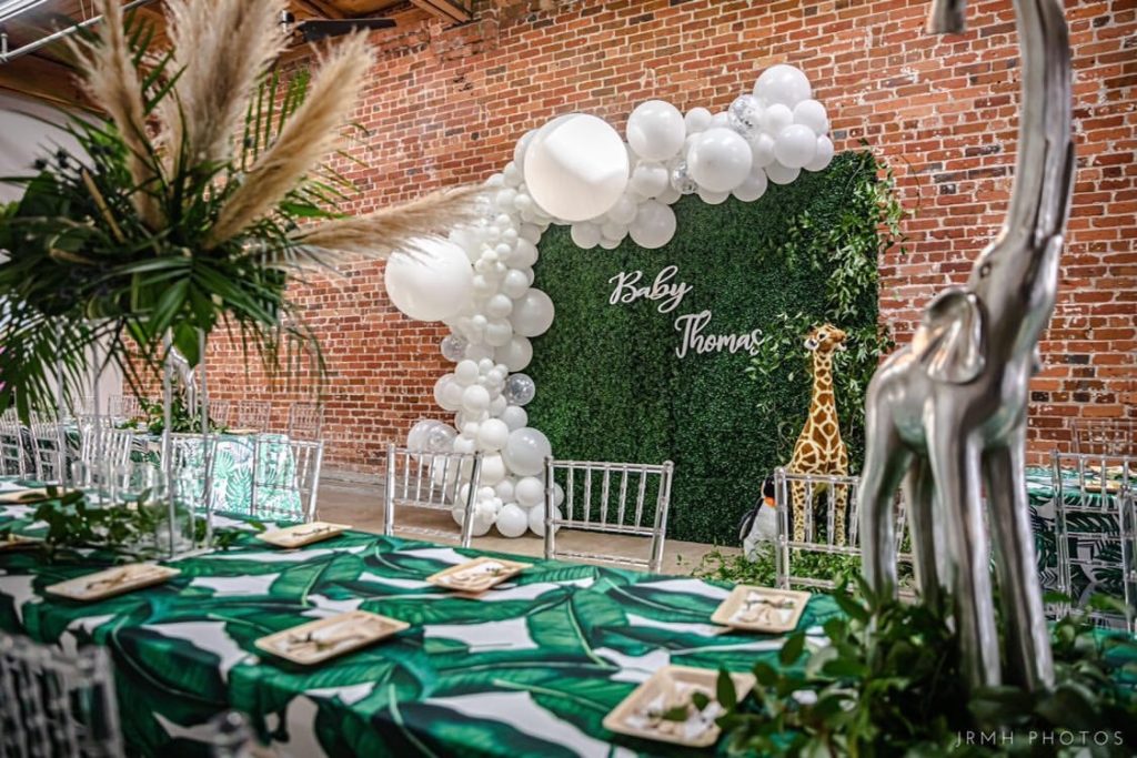 Ronin 2 decorated with jungle themed baby shower with elephant statue on the long table and balloon arch decor. 