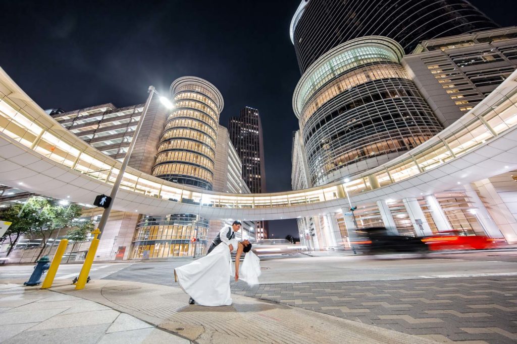 Groom dips bride for nighttime wedding portrait outside Whitehall Houston. 