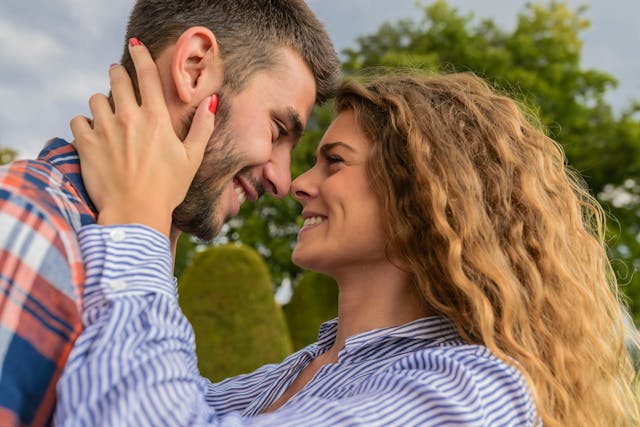 A man and a woman looking at each other and smiling